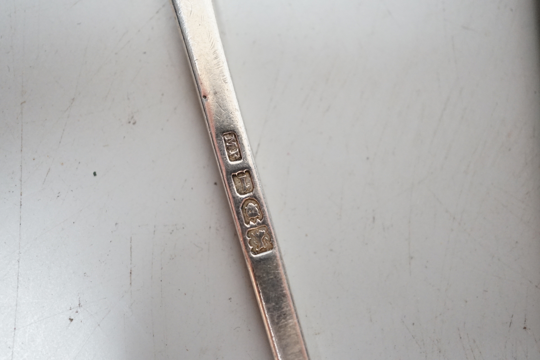 A pair of Edwardian silver apostle spoons, London, 1906 and an ARP badge